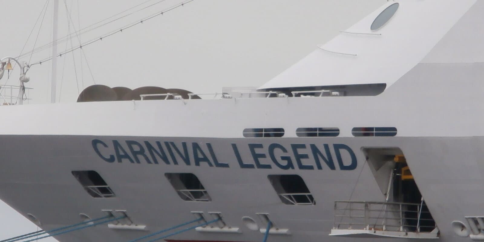 Bow of Carnival Legend with ship name lettering and mast, photographed in port
