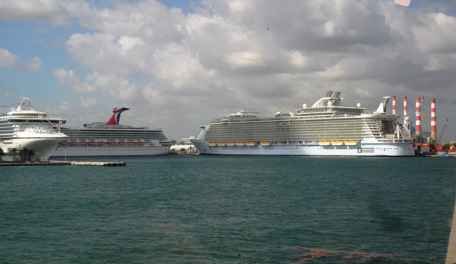 Multiple cruise ships docked at Port Everglades with port buildings and Lake Mabel in the foreground at Fort Lauderdale, Florida